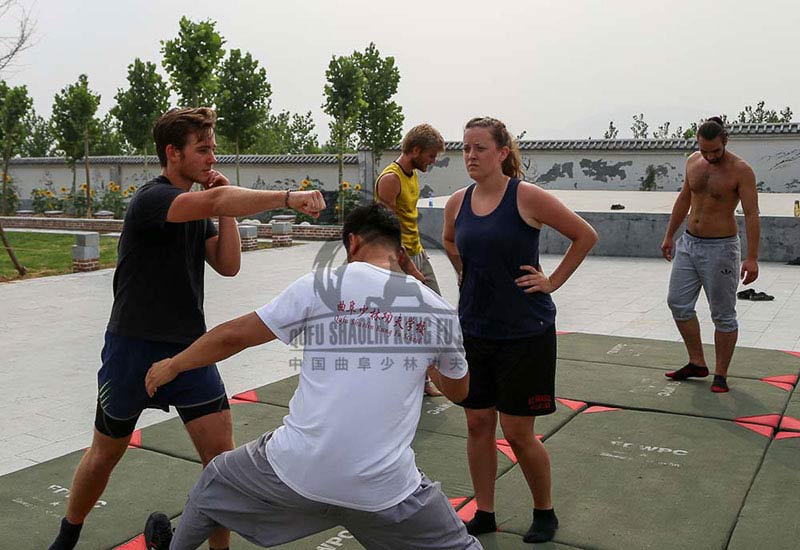 Master teaching Kung Fu punch