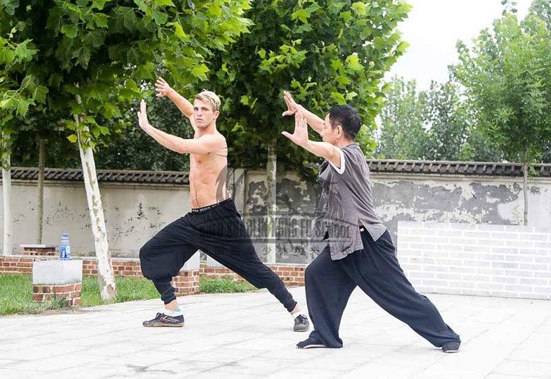master and students training Tai Chi